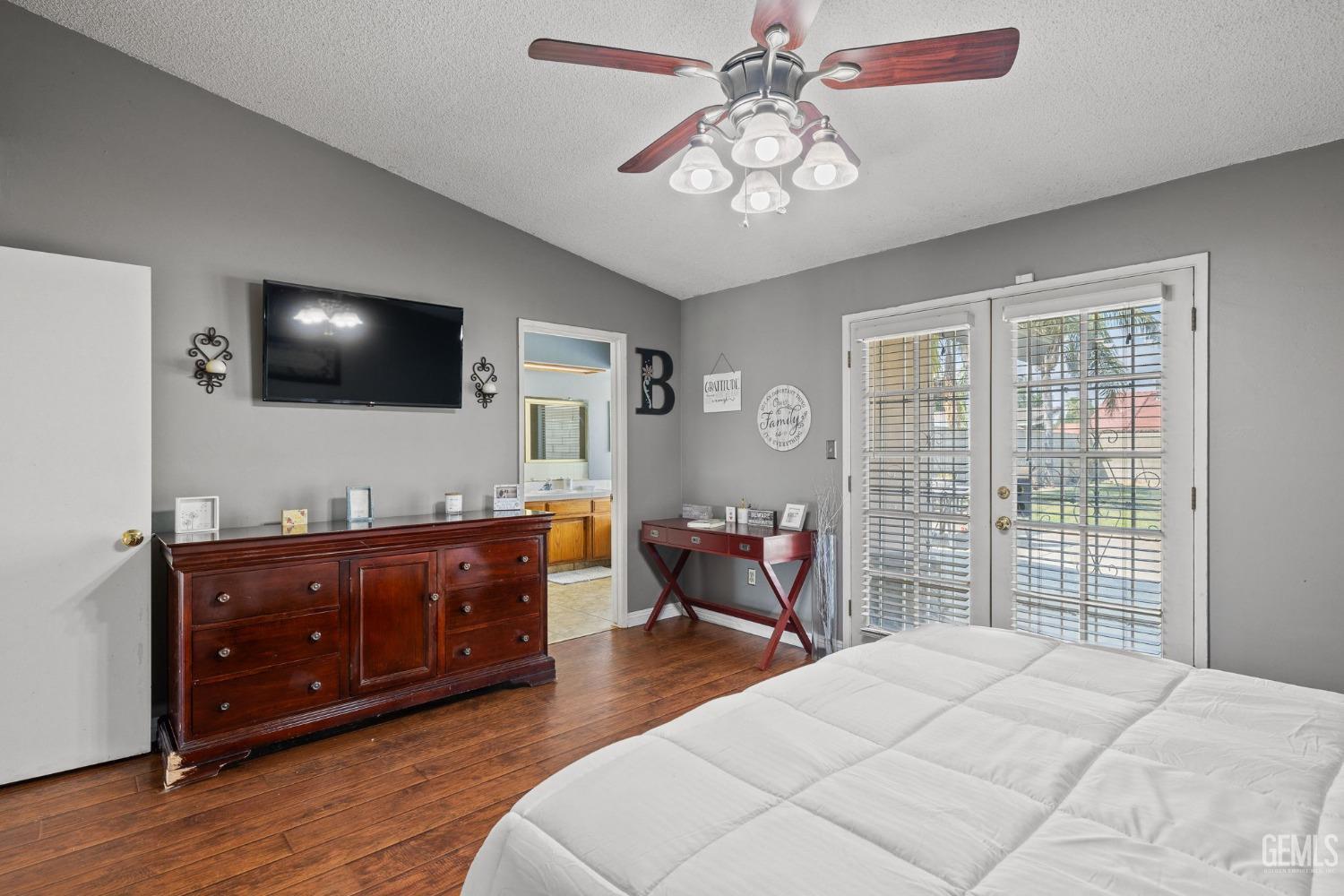 Undisclosed Address Bakersfield, CA 93311 - Photo 28 of 40 a spacious bedroom with a bed and a flat screen tv