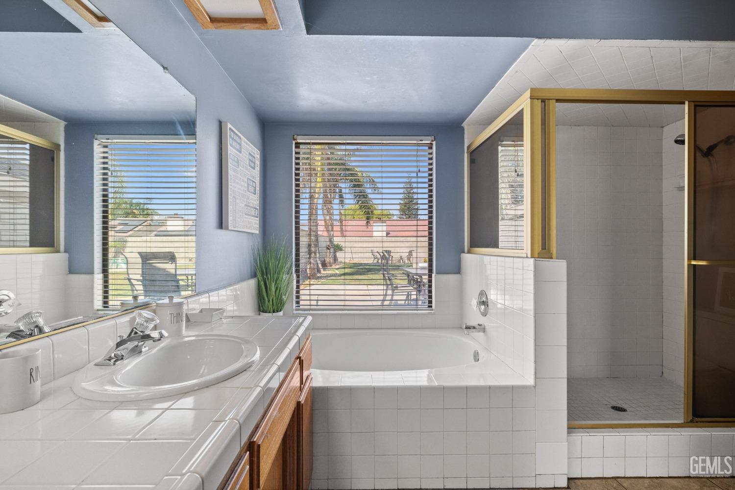 Undisclosed Address Bakersfield, CA 93311 - Photo 30 of 40 a bathroom with a tub sink and mirror
