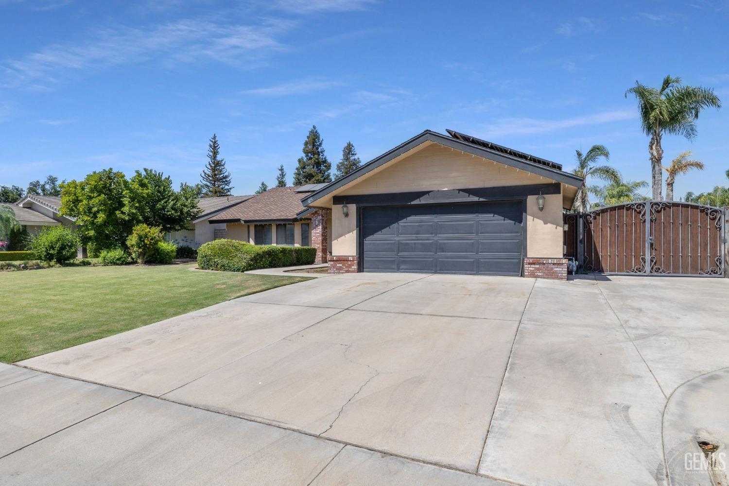Undisclosed Address Bakersfield, CA 93311 - Photo 3 of 40 a front view of a house with a yard and garage