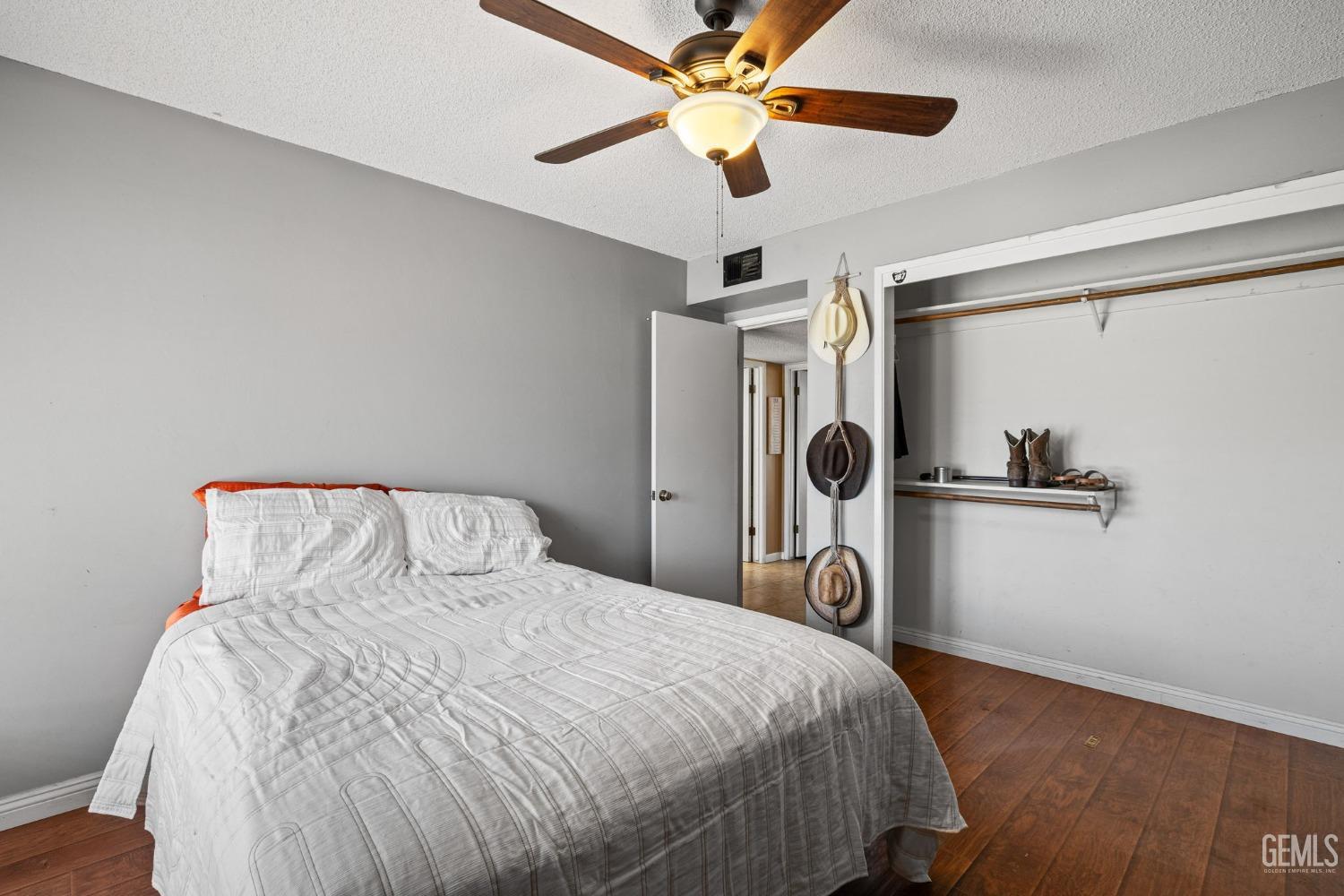 Undisclosed Address Bakersfield, CA 93311 - Photo 33 of 40 a bedroom with a bed and a ceiling fan