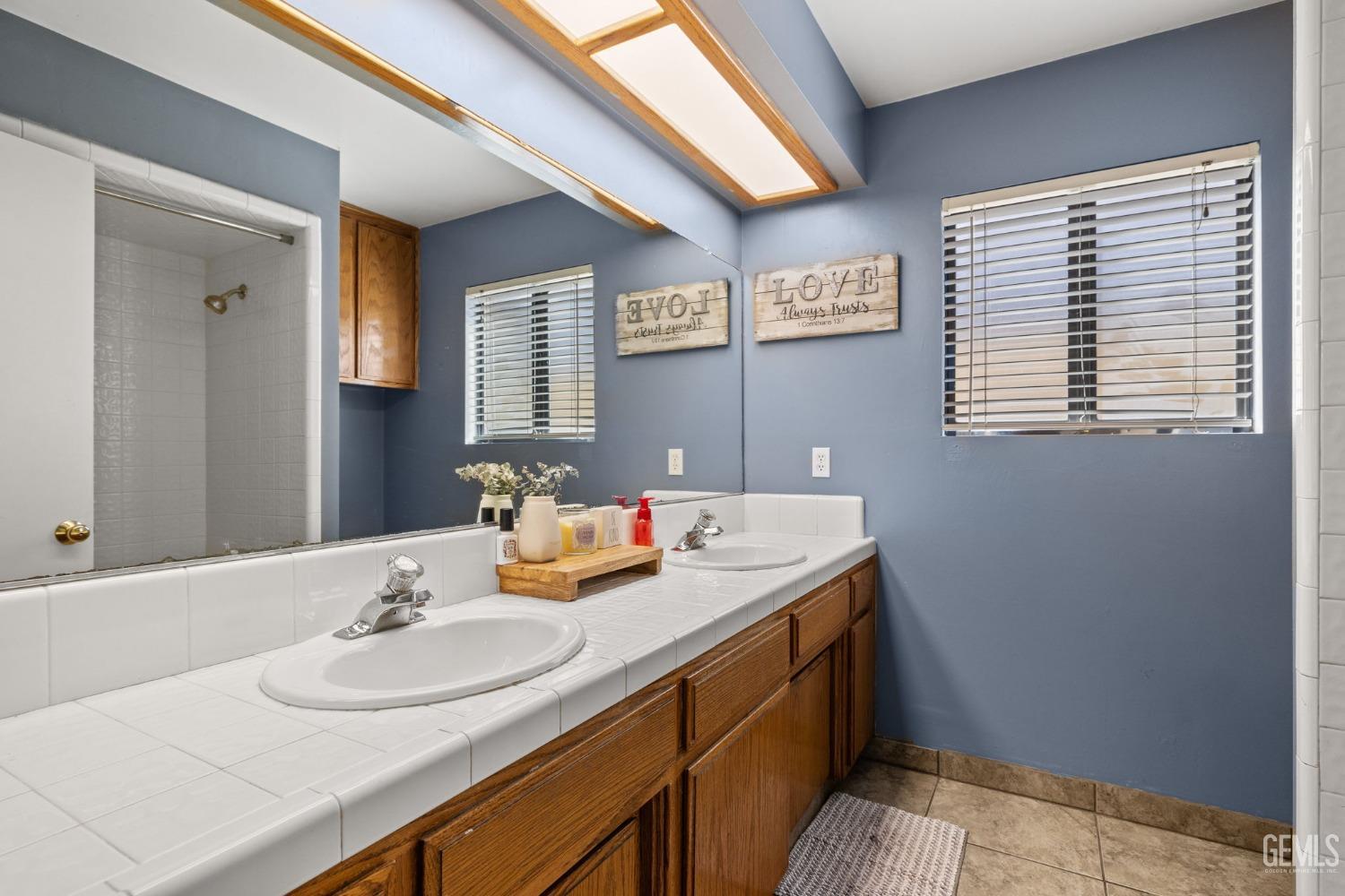 Undisclosed Address Bakersfield, CA 93311 - Photo 34 of 40 a bathroom with a granite countertop sink and a mirror