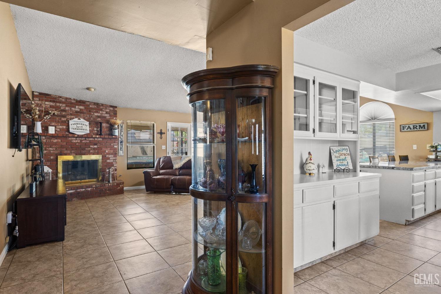 Undisclosed Address Bakersfield, CA 93311 - Photo 5 of 40 a kitchen with granite countertop a refrigerator and a stove top oven