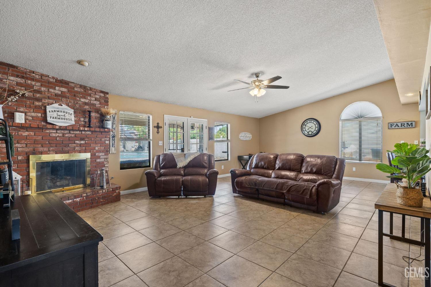 Undisclosed Address Bakersfield, CA 93311 - Photo 7 of 40 a living room with furniture and a fireplace