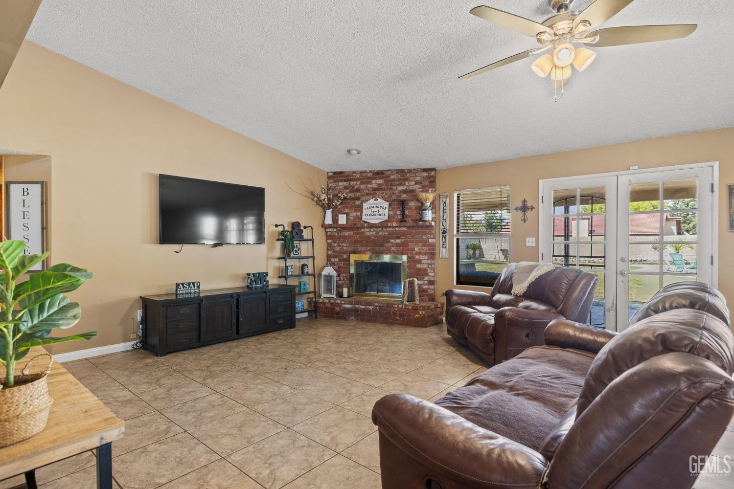 Undisclosed Address Bakersfield, CA 93311 - Photo 8 of 40 a living room with furniture a flat screen tv and a chandelier
