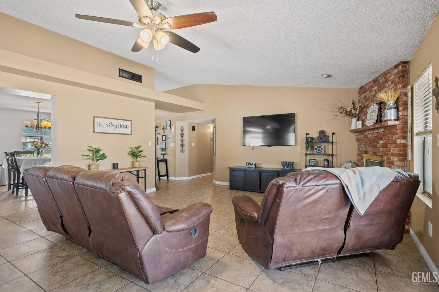 Undisclosed Address Bakersfield, CA 93311 - Photo 9 of 40 a living room with furniture and a flat screen tv