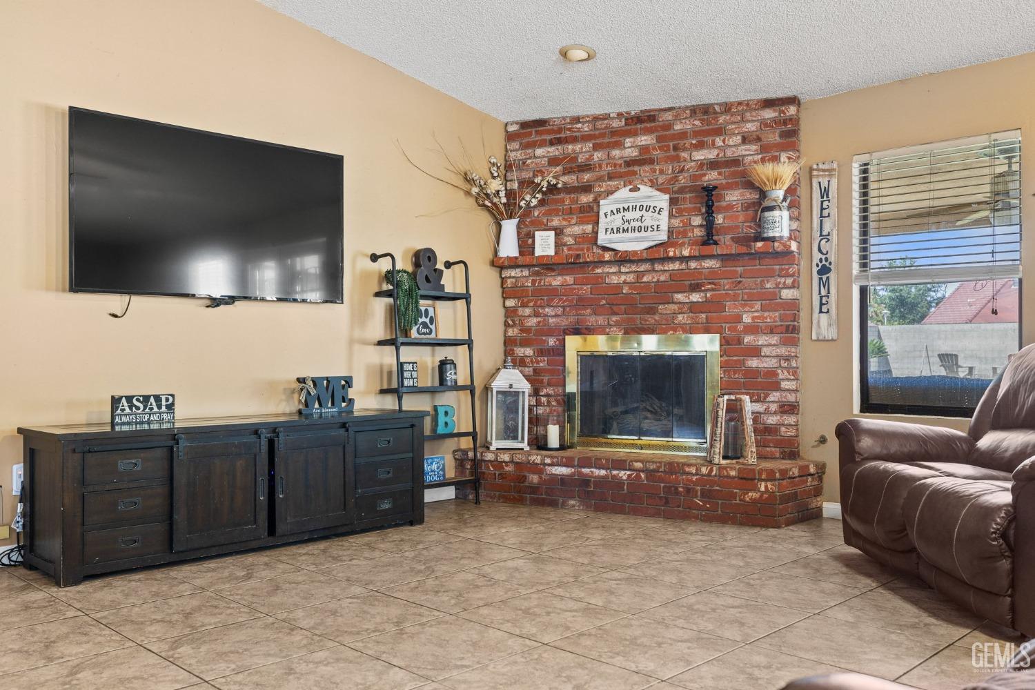 Undisclosed Address Bakersfield, CA 93311 - Photo 10 of 40 a living room with furniture and a flat screen tv