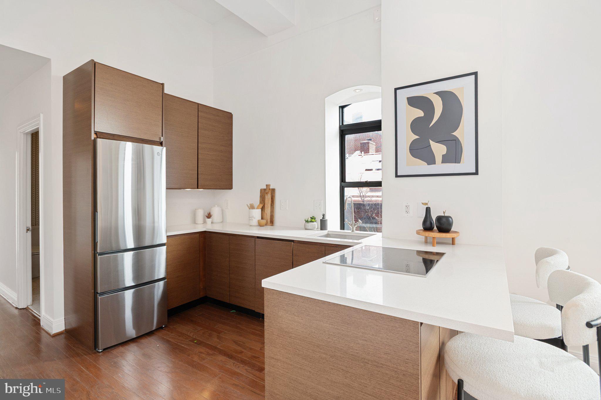 3299 K Street Northwest, Unit 401 Washington, DC 20007 - Photo 7 of 18 a kitchen with stainless steel appliances a refrigerator and a sink
