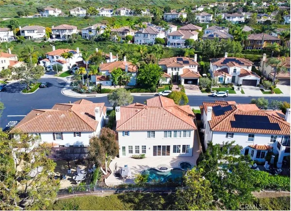 an aerial view of multiple houses with yard