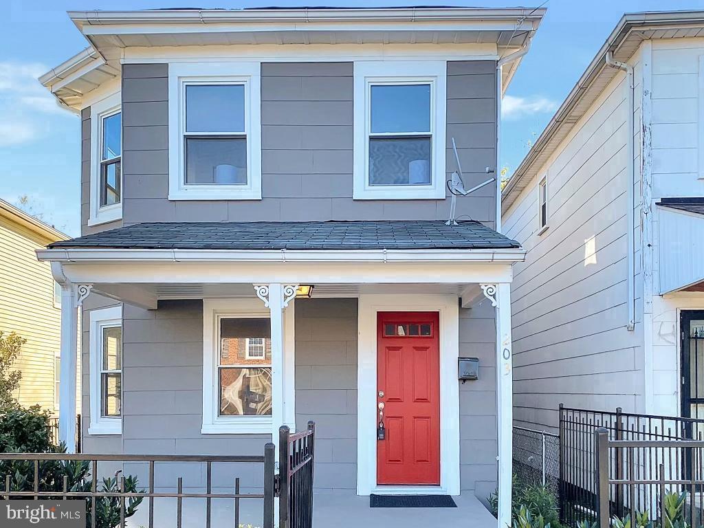 Charming home with a vibrant red door.