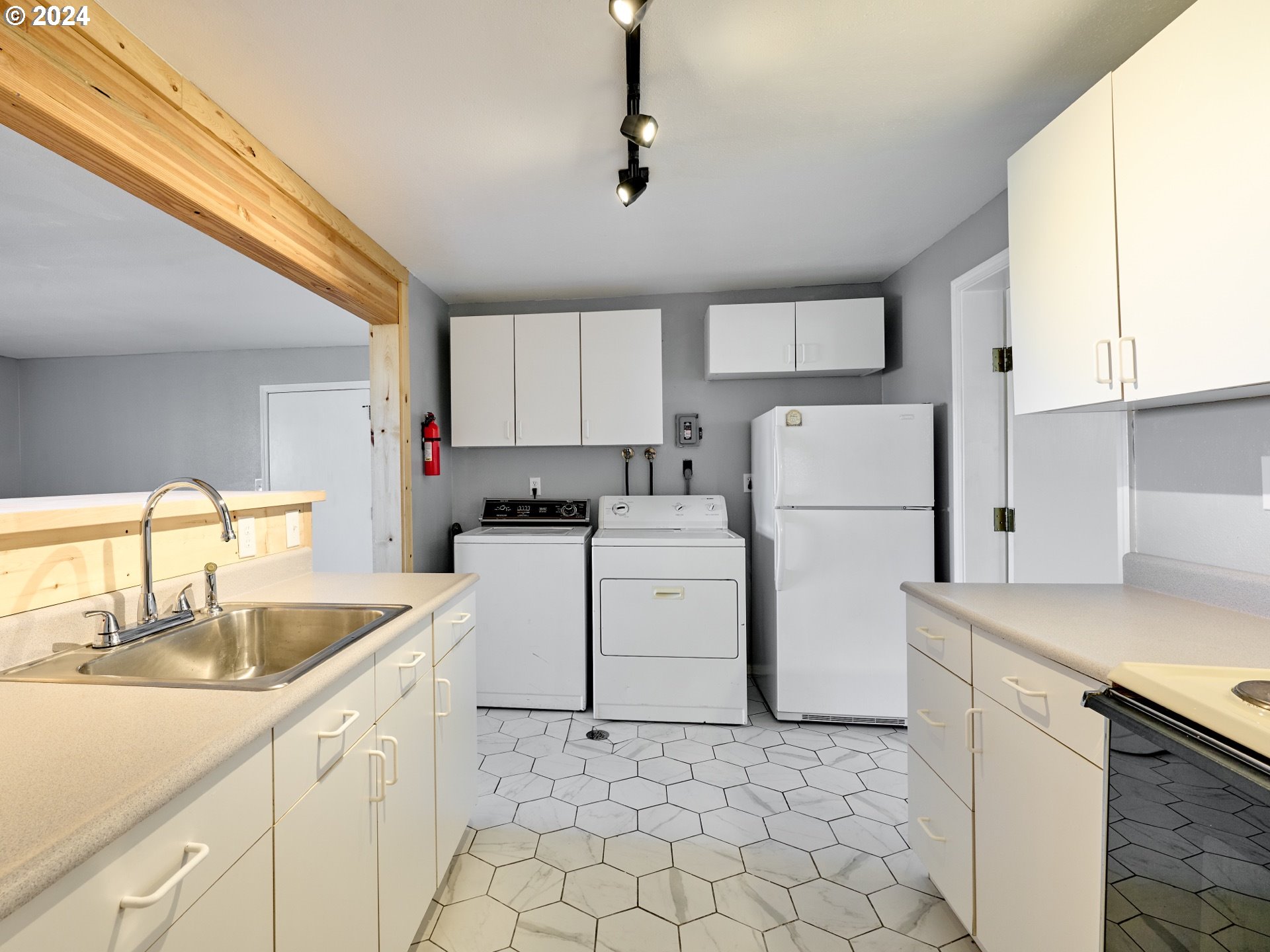 12795 Beck Road Dallas, OR 97338 - Photo 26 of 48 a kitchen with sink a refrigerator and white cabinets