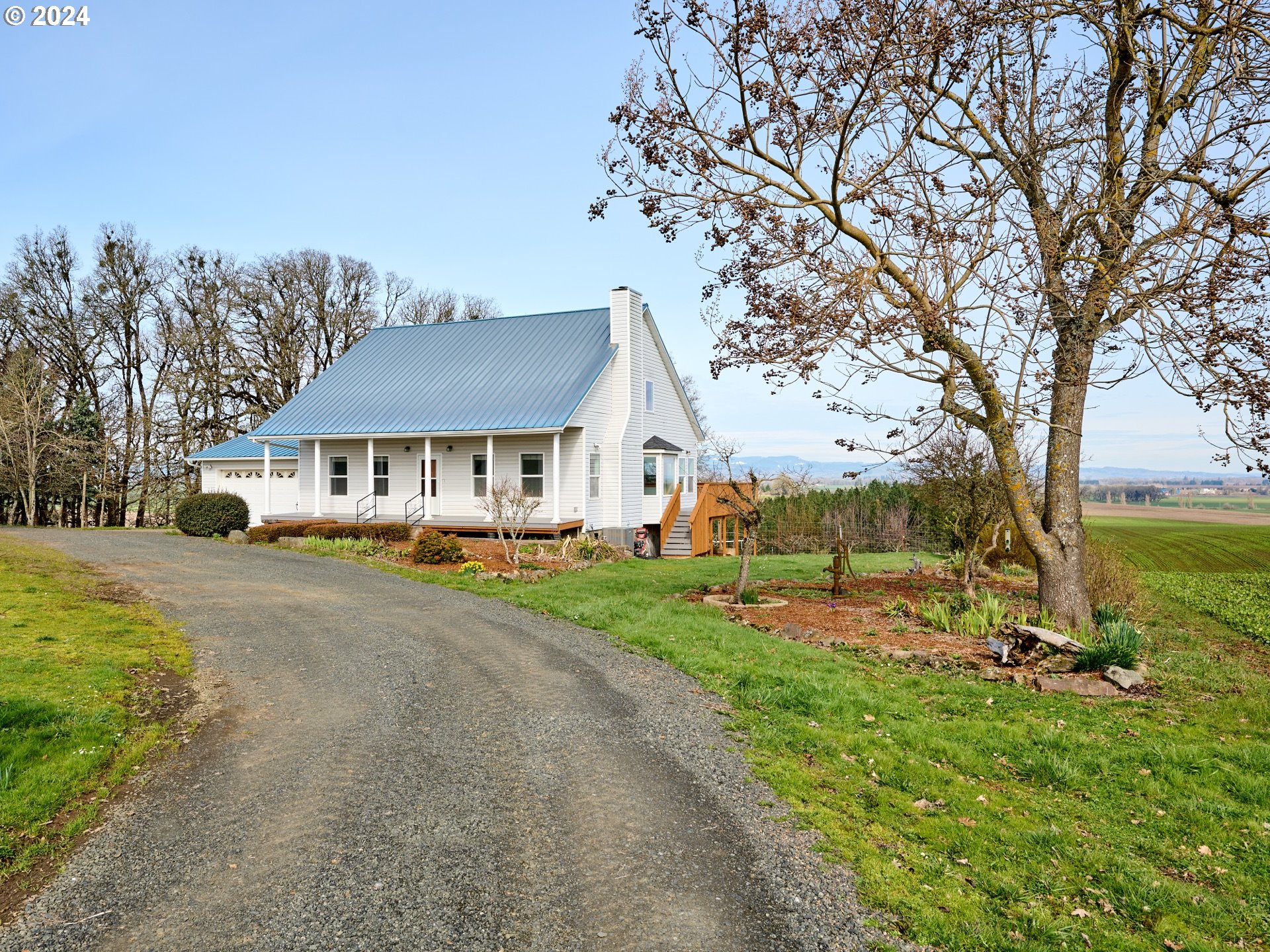 12795 Beck Road Dallas, OR 97338 - Photo 31 of 48 a front view of a house with a yard table and chairs