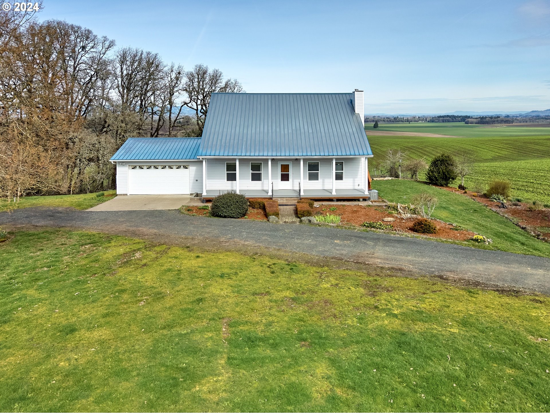 12795 Beck Road Dallas, OR 97338 - Photo 4 of 48 a front view of a house with a garden and lake view