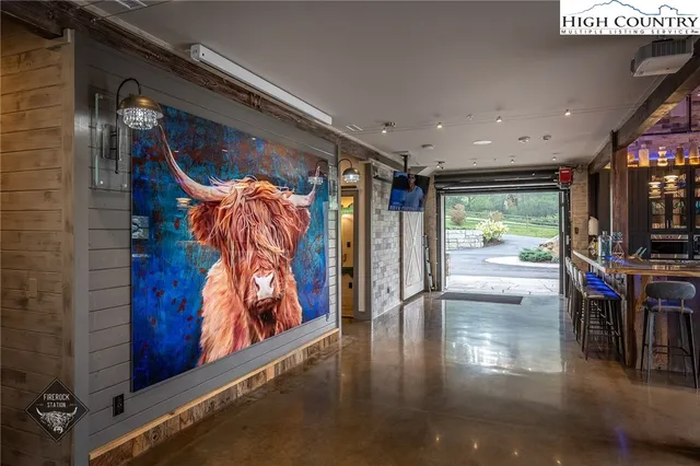 a view of a hallway with wooden floor and door