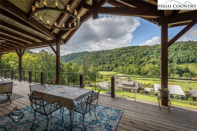 a view of a patio with table and chairs and wooden floor