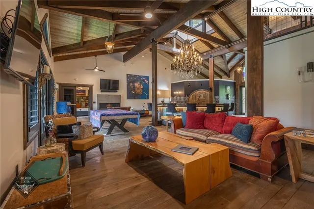 a living room with furniture and a chandelier