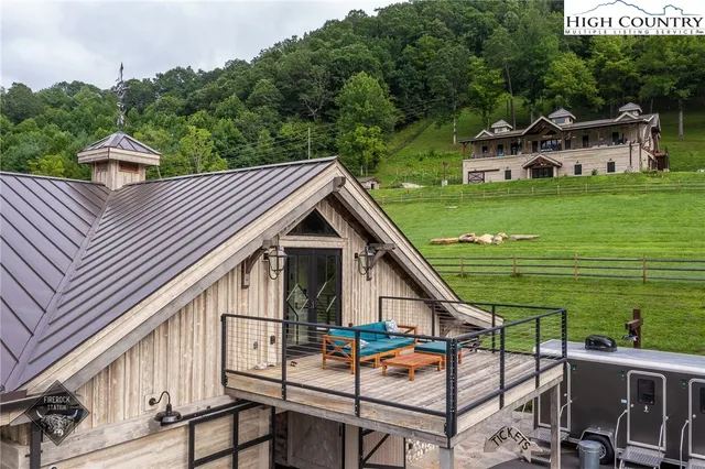 a view of a house with backyard porch and sitting area