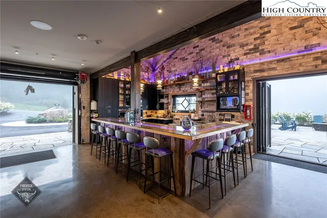 a room with stainless steel appliances lots of wooden furniture