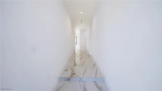 a kitchen with stainless steel appliances a sink a stove a microwave and a refrigerator