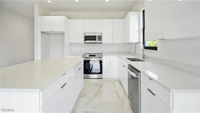 a kitchen with a sink cabinets and window