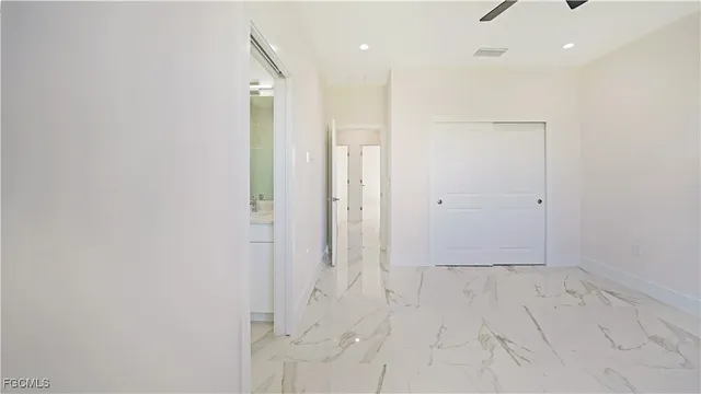 a white toilet sitting next to a shower