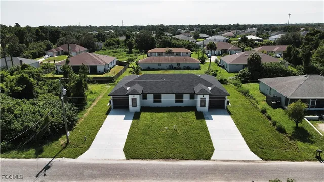 an aerial view of multiple houses with a yard