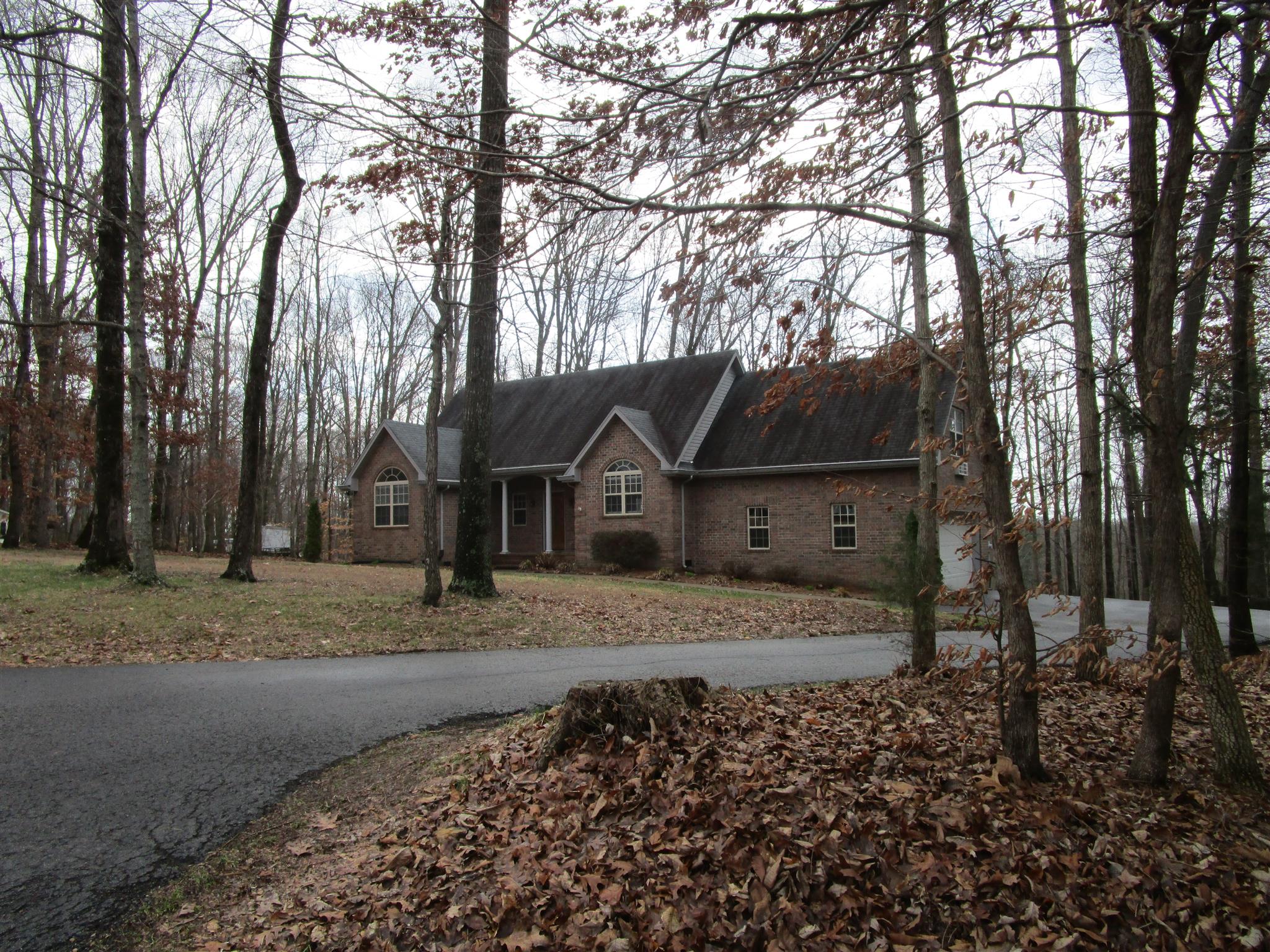 a house that has a tree in front of it