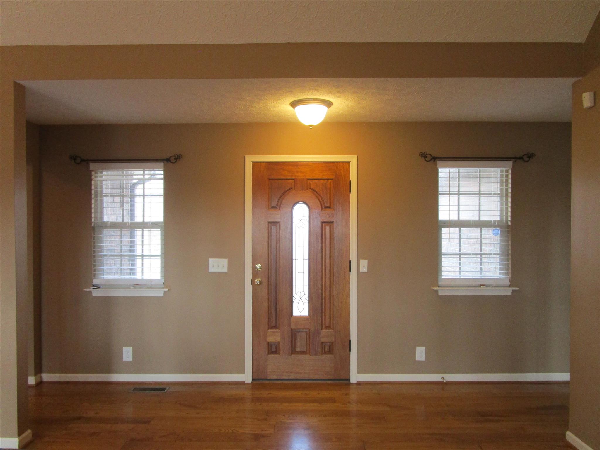 136 North Leath Road Portland, TN 37148 - Photo 11 of 30 an empty room with wooden floor and windows