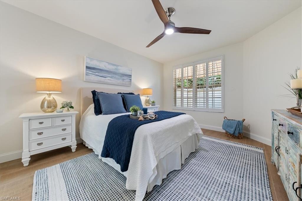 171 Via Napoli Naples, FL 34105 - Photo 22 of 45 a bedroom with a large bed and a window
