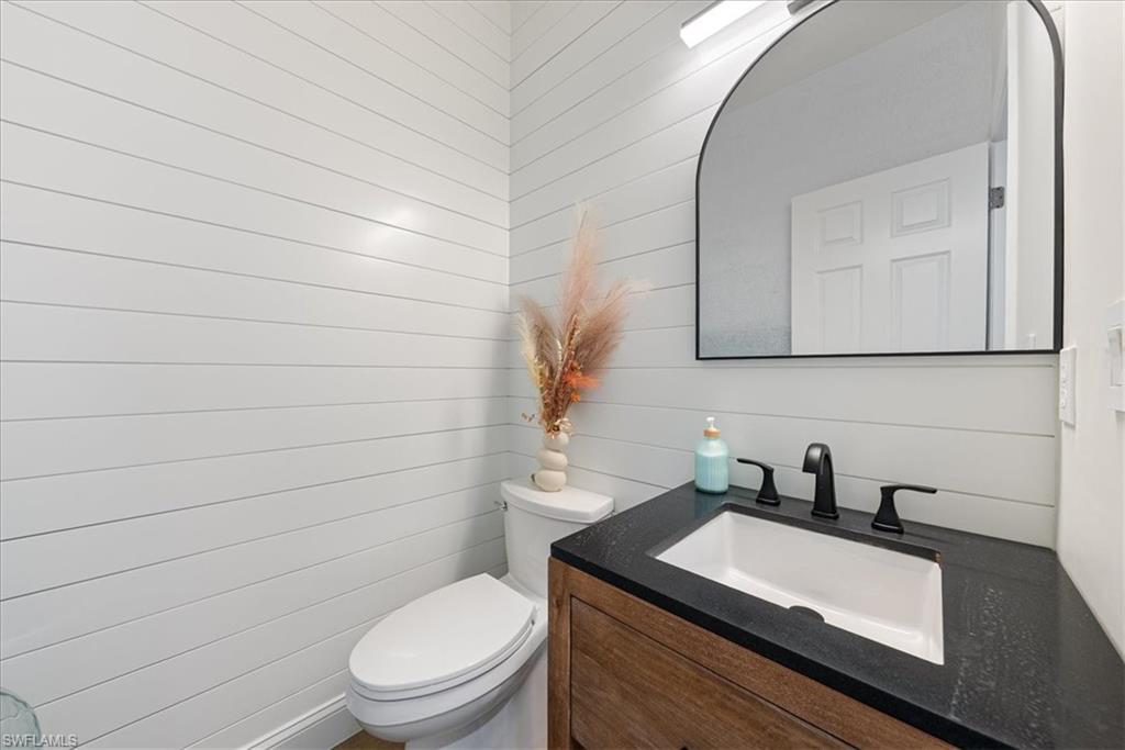 171 Via Napoli Naples, FL 34105 - Photo 27 of 45 a bathroom with a sink toilet and mirror