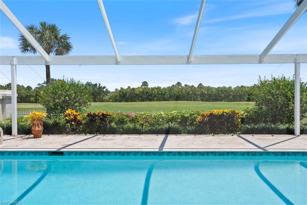 171 Via Napoli Naples, FL 34105 - Photo 28 of 45 a view of a swimming pool with a patio
