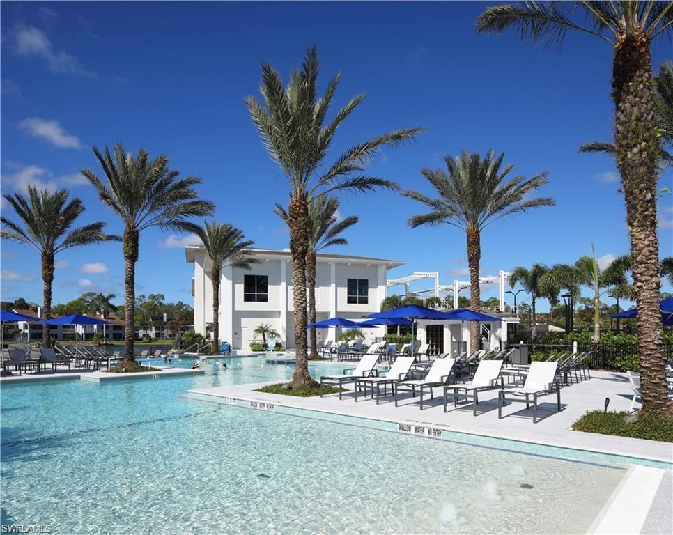 171 Via Napoli Naples, FL 34105 - Photo 39 of 45 a view of a swimming pool with outdoor seating and a garden