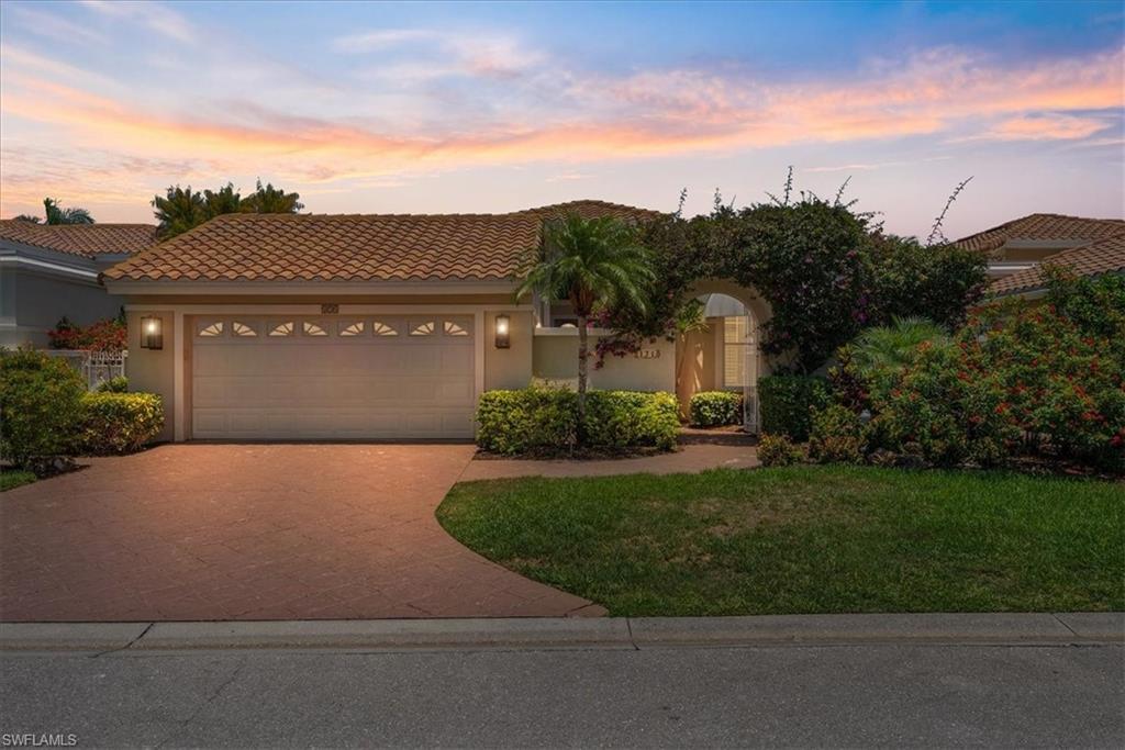 171 Via Napoli Naples, FL 34105 - Photo 5 of 45 front view of a house with a yard