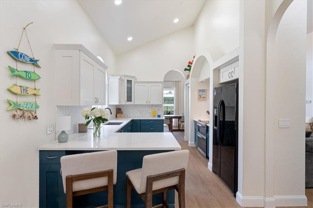 171 Via Napoli Naples, FL 34105 - Photo 10 of 45 a kitchen with a table and chairs in it