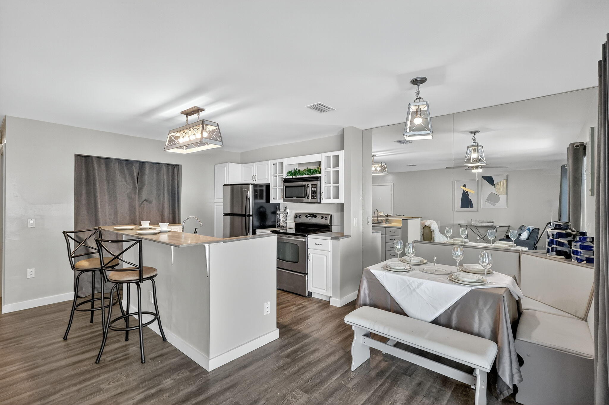 5785 Southeast Collins Avenue Stuart, FL 34997 - Photo 15 of 49 a living room with furniture a dining table and kitchen view