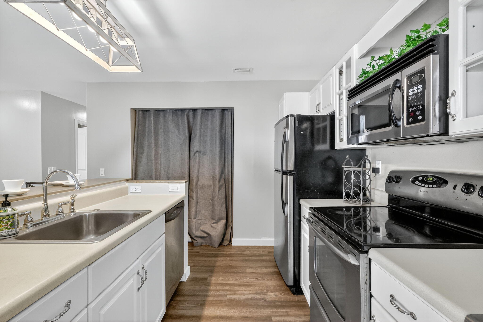 5785 Southeast Collins Avenue Stuart, FL 34997 - Photo 17 of 49 a kitchen that has a sink and stainless steel appliances