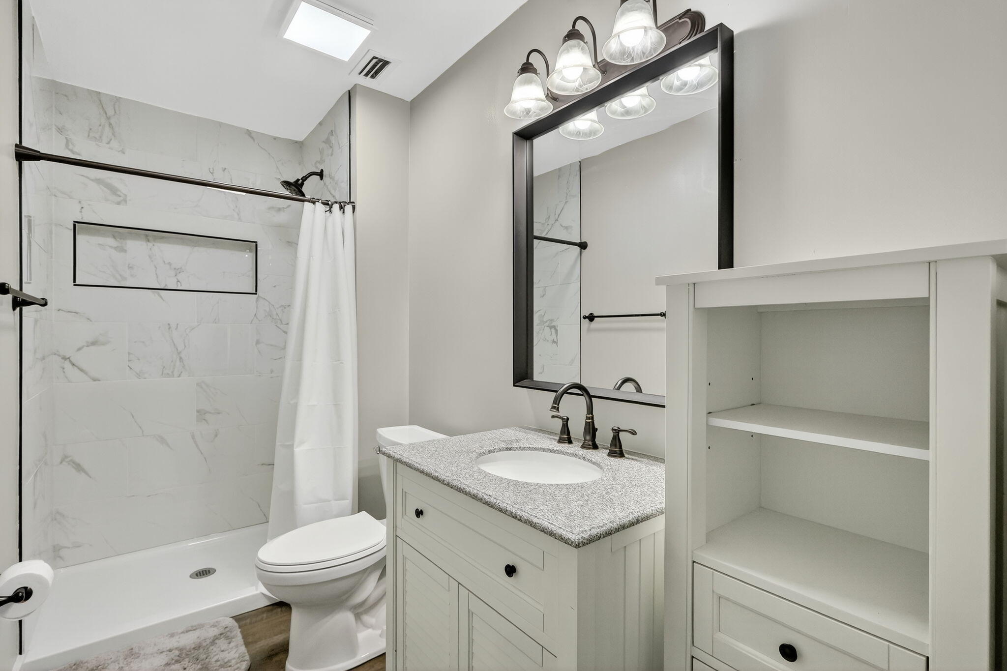 5785 Southeast Collins Avenue Stuart, FL 34997 - Photo 22 of 49 a bathroom with a sink a toilet and shower