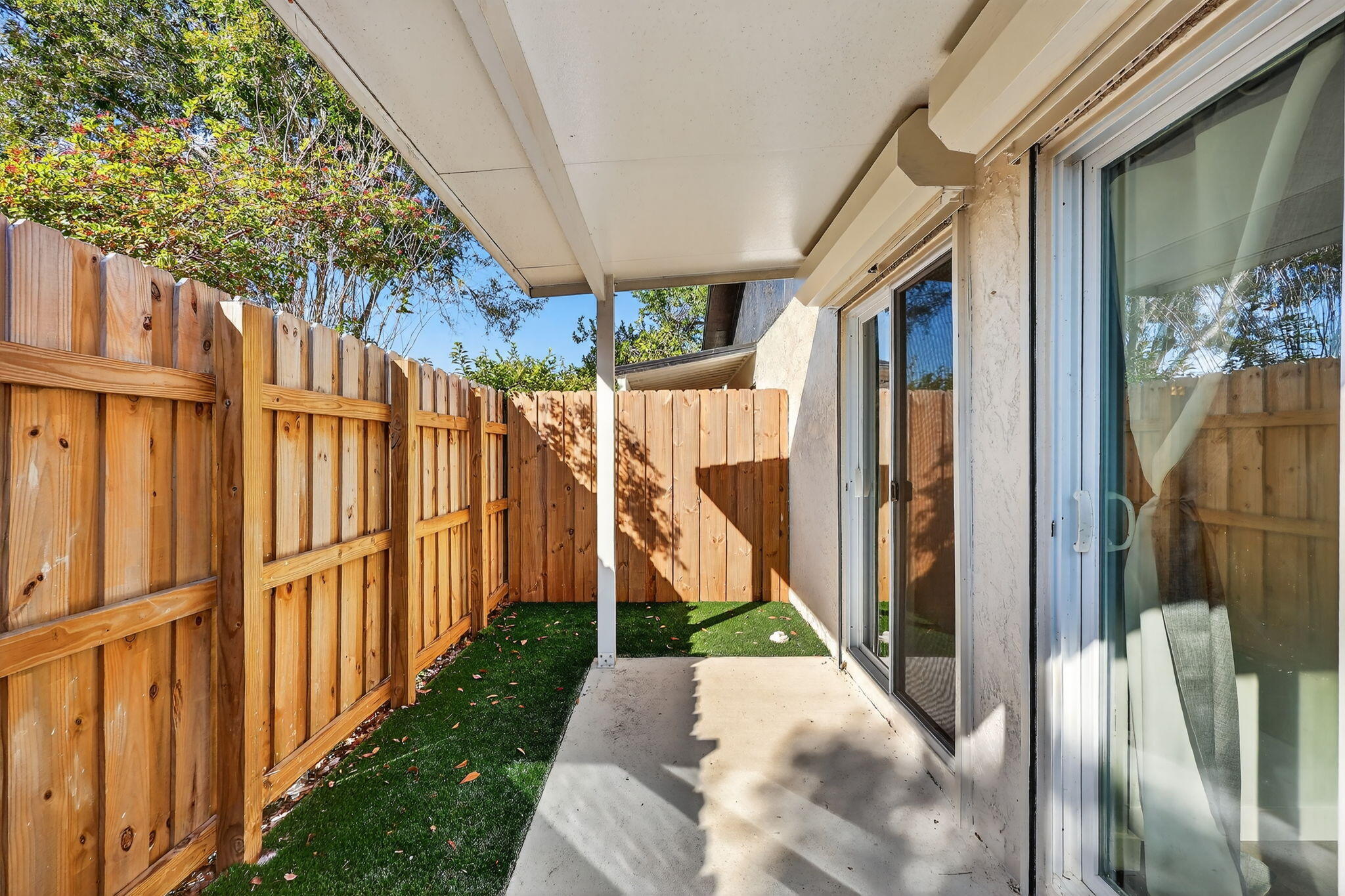 5785 Southeast Collins Avenue Stuart, FL 34997 - Photo 32 of 49 a view of a house with a small yard and wooden fence