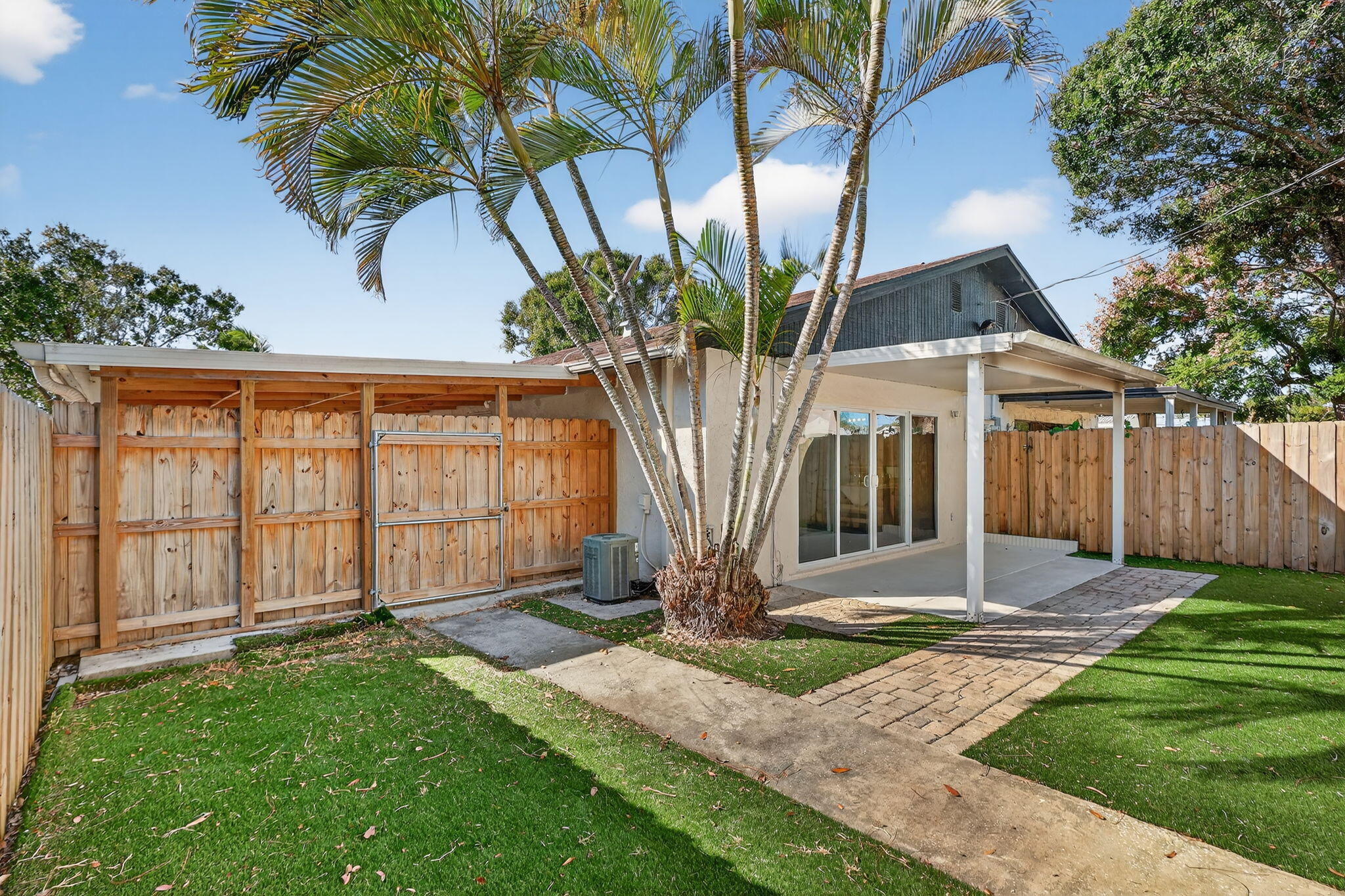5785 Southeast Collins Avenue Stuart, FL 34997 - Photo 37 of 49 a front view of a house with garden