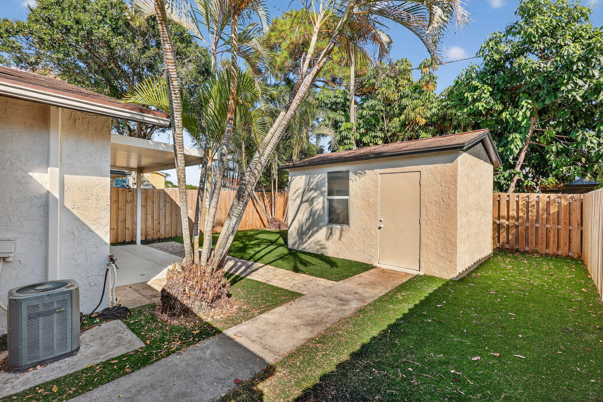 5785 Southeast Collins Avenue Stuart, FL 34997 - Photo 38 of 49 a front view of a house with garden