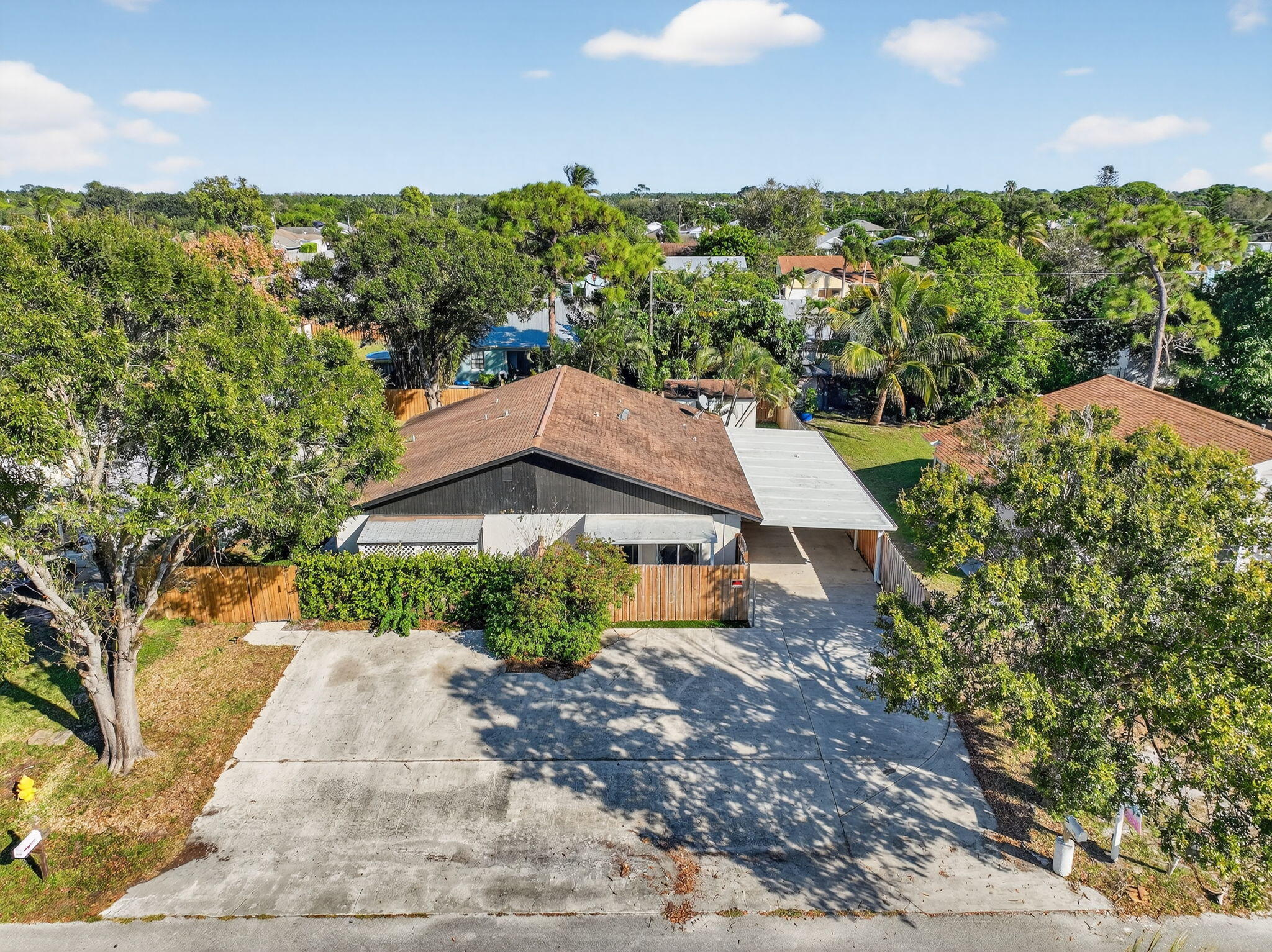 5785 Southeast Collins Avenue Stuart, FL 34997 - Photo 42 of 49 a view of a garden with a house in the background