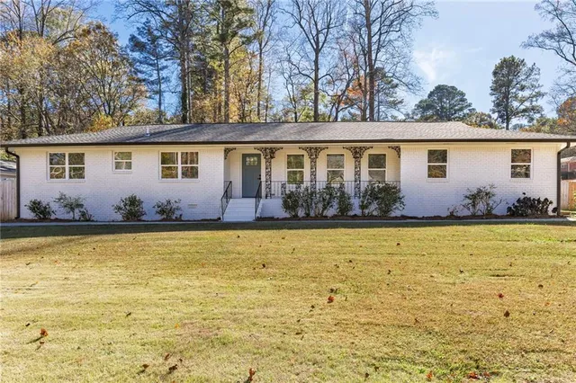 a front view of house with garden and outdoor seating