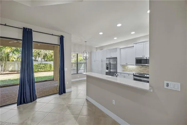 a kitchen with a refrigerator sink and cabinets