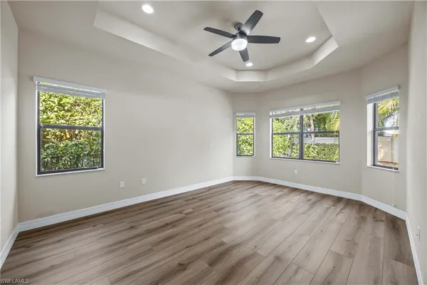 a large white kitchen with a large window