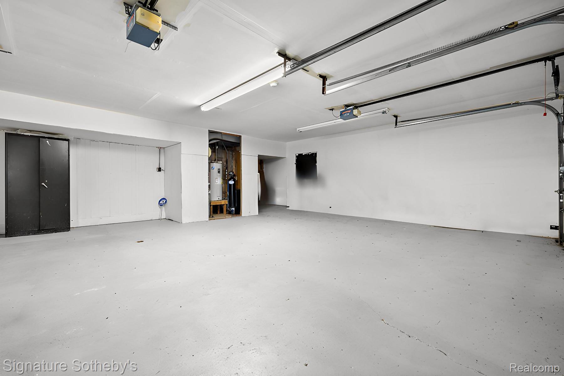 16385-16475 17 1/2 Mile Road Marshall, MI 49068 - Photo 42 of 48 Garage with a garage door opener and water heater