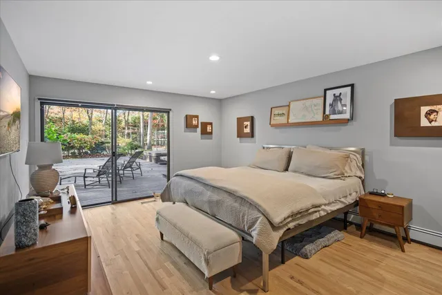 a spacious bedroom with a bed and a large window