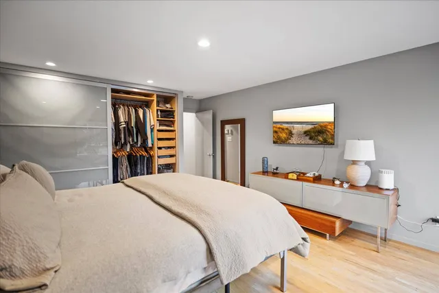 a bedroom with a bed and a flat screen tv