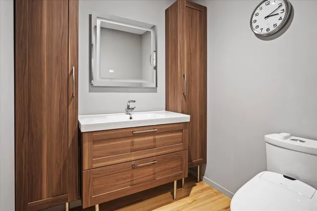 a bathroom with a toilet a sink and a mirror