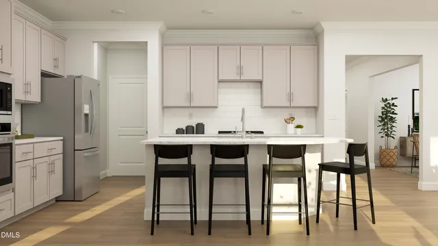 a kitchen with stainless steel appliances granite countertop a table chairs refrigerator and a sink