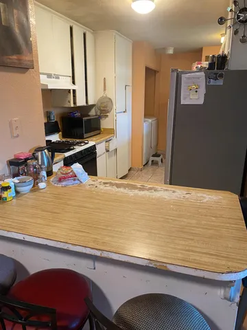 a room with furniture pool table and a flat screen tv