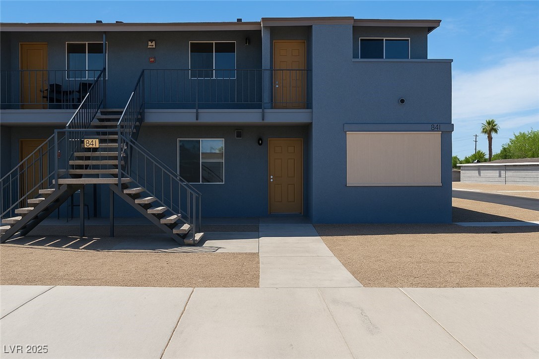 View of front of house featuring stairway and stuc